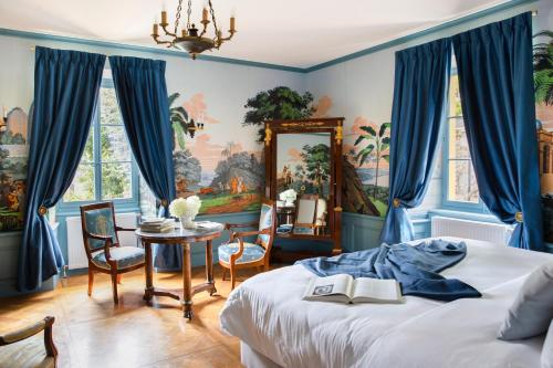 a bedroom with a bed and a table with a mirror at Chateau de Marnand in Granges-près-Marnand