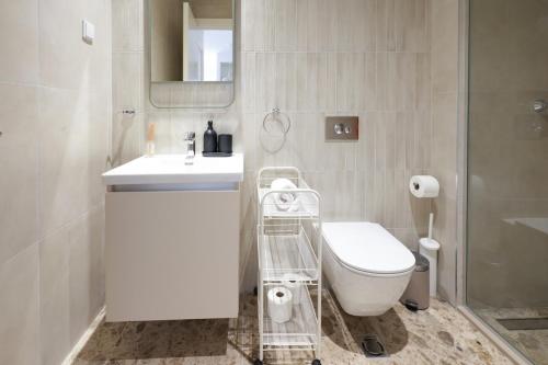 a bathroom with a toilet and a sink and a mirror at Scala Reale in Sajmište