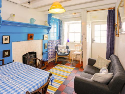 a living room with a couch and a fireplace at Blue - Uk43119 in Trefor