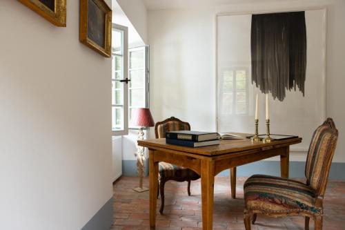 a room with a wooden table and two chairs at Chateau de Marnand in Granges-près-Marnand