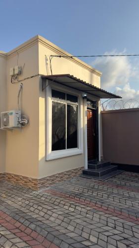 a house with a window on the side of it at Grace Haven Airport Day-Use & Overnight Stays Hotel in Dar es Salaam