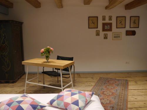 a room with a table with a vase of flowers on it at Chateau de Marnand in Granges-près-Marnand