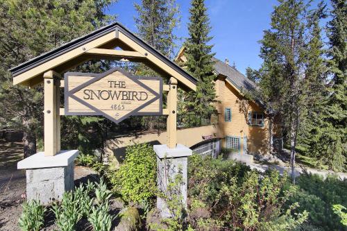 a sign that says the snowword in front of a house at The Snowbird by Whiski Jack in Whistler