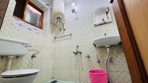 a bathroom with a toilet and a sink at Hotel Indra in Srinagar