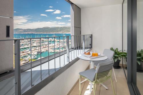 a balcony with a table and chairs and a view of the ocean at Akademis - Fit Split in Split