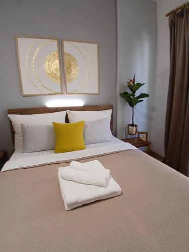a bed with two towels sitting on top of it at Luxury Spot Xanthi in Xanthi