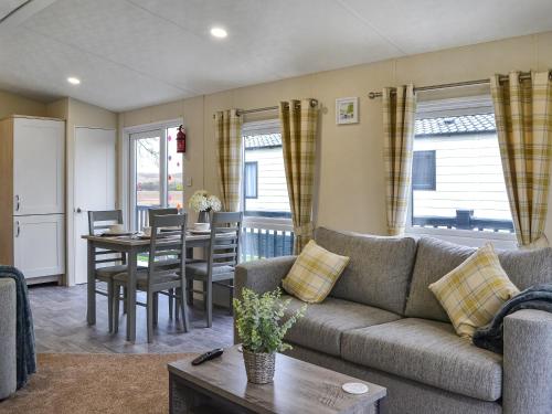 a living room with a couch and a table at Rosie's Retreat - Uk46724 in Bridlington