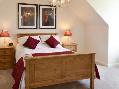 a bedroom with a bed and two night stands and two lamps at Eilean View Island View in Midtown Brae