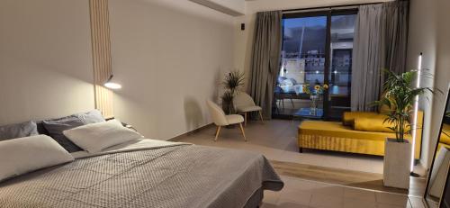 a bedroom with a bed and a living room at Thalori Suites in Kalamata