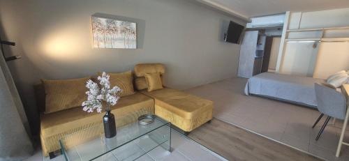 a small living room with a couch and a table at Thalori Suites in Kalamata