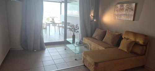 a living room with a couch and a table at Thalori Suites in Kalamata
