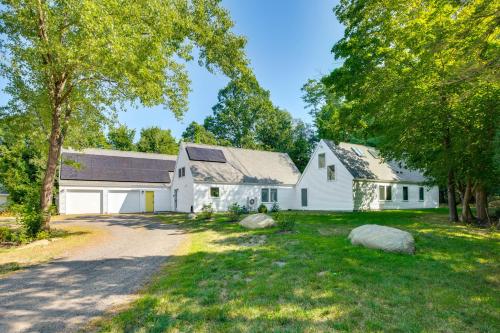 a white barn with a driveway and trees at Custom-Built Home Near Piscataqua River! in Eliot
