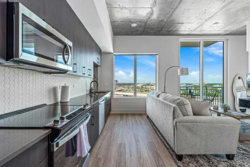 a kitchen with a couch and a chair at 14th Floor SkySuite - DT Views! with Pool & Gym in Tampa