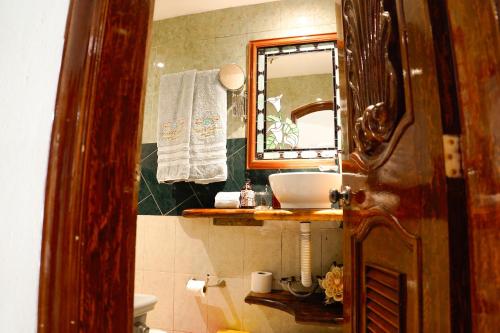 a bathroom with a sink and a mirror at Monyoli Hotel & Boutique in Acapulco