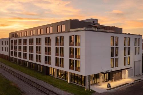 a large white building with a sunset in the background at Trendy Ybor Studio Free Parking Steps to DT in Tampa