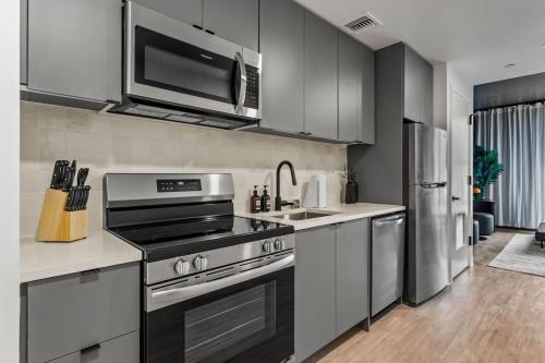 a kitchen with a stove and a refrigerator at Trendy Ybor Studio Free Parking Steps to DT in Tampa