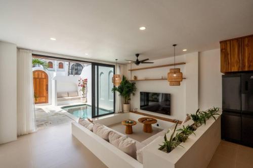a living room with a large couch and a fireplace at Amal Villa #10 by Bali Bliss Properties in Mengwi