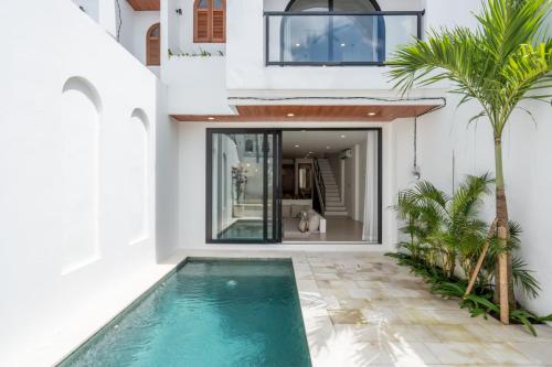 a villa with a swimming pool and a house at Amal Villa #10 by Bali Bliss Properties in Mengwi