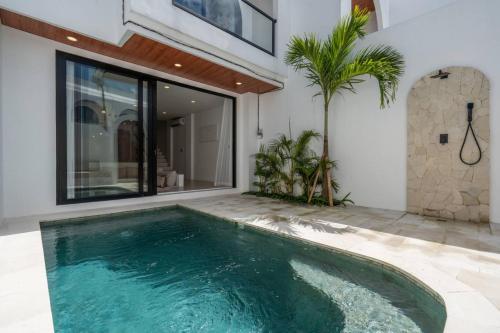 a swimming pool in the middle of a house at Amal Villa #10 by Bali Bliss Properties in Mengwi