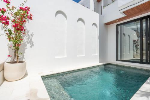 a swimming pool in a house with a window at Amal Villa #10 by Bali Bliss Properties in Mengwi