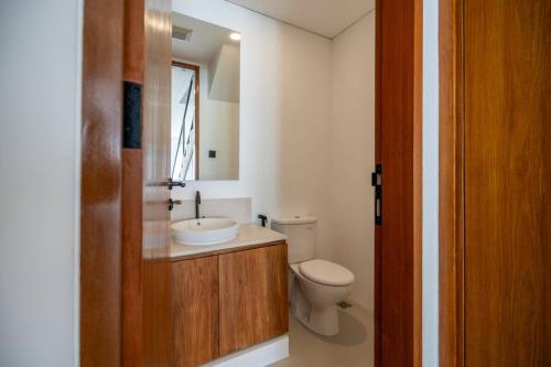 a bathroom with a white toilet and a sink at Amal Villa #10 by Bali Bliss Properties in Mengwi
