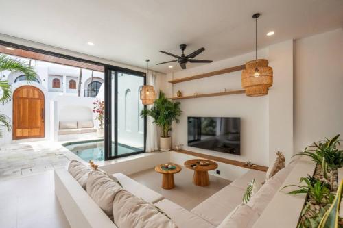 a living room with a white couch and a table at Amal Villa #10 by Bali Bliss Properties in Mengwi