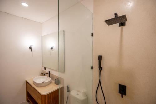 a bathroom with a shower with a sink and a mirror at Amal Villa #10 by Bali Bliss Properties in Mengwi