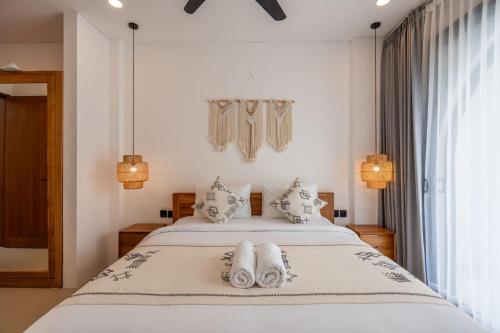 a bedroom with a bed with towels on it at Amal Villa #10 by Bali Bliss Properties in Mengwi