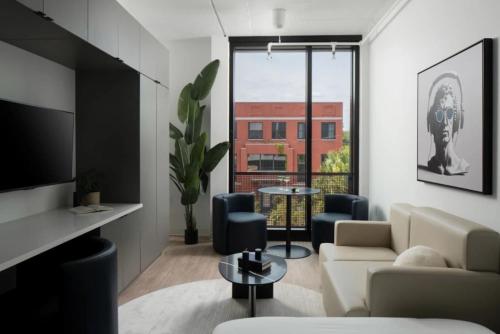 a living room with a couch and a table at Ybor 2BD Haven Free Parking Close to DT in Tampa