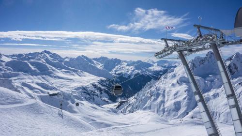 a ski lift on top of a snow covered mountain at DER ERLACHER Alpenrefugium 1874 LUXERY & PRIVACY by Belle-Stay in Jochberg
