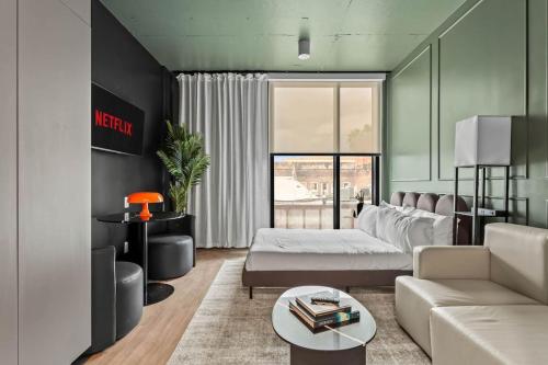a living room with a couch and a table at Sleek Ybor Studio Free Pool Minutes to DT in Tampa