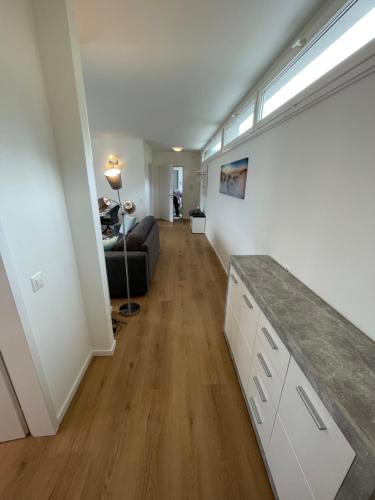 a kitchen and living room with a couch and a table at Casa Aviva in Muralto