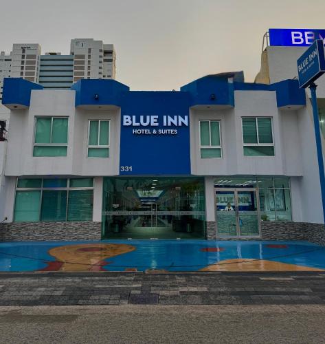 a building with a blue inn sign in front of it at Blue Inn Hotel & Suites in Mazatlán