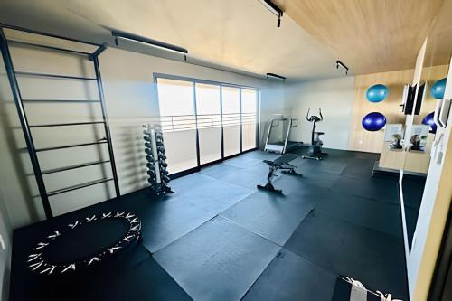 an empty room with a gym with a treadmill at *Loft Refúgio Urbano | Estilo e Conforto. in Uberlândia