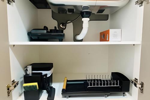 a shelf with a hair dryer and a sink at *Loft Refúgio Urbano | Estilo e Conforto. in Uberlândia