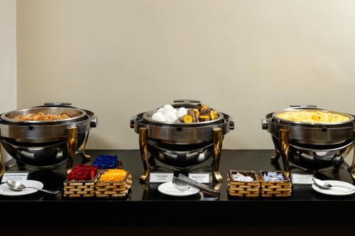 two large pots of food sitting on a table at Savoy Othon Lite in Rio de Janeiro