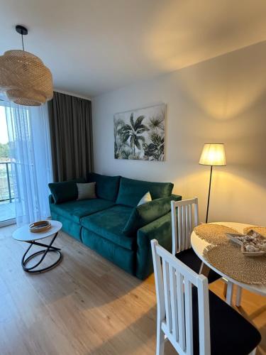 a living room with a blue couch and a table at Nicole in Łagów