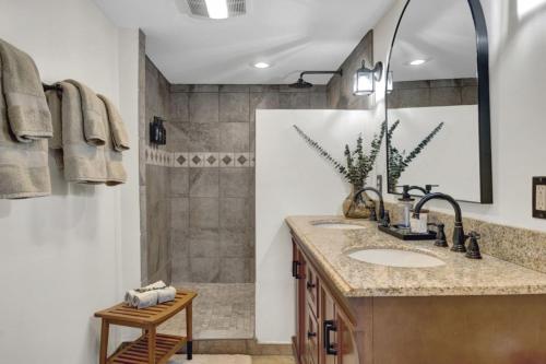 a bathroom with a sink and a shower at Spacious Luxe Condo in Historic Downtown Wolfeboro in Wolfeboro