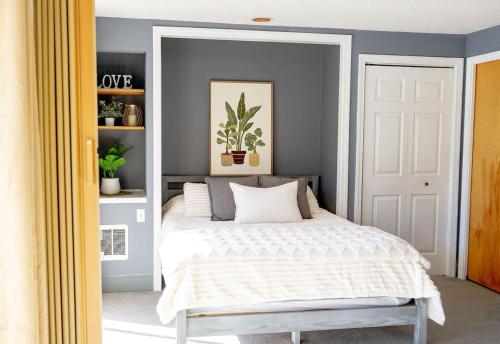 a bedroom with a bed with a white comforter at Walk to Concerts Beach with Pool View in Gilford