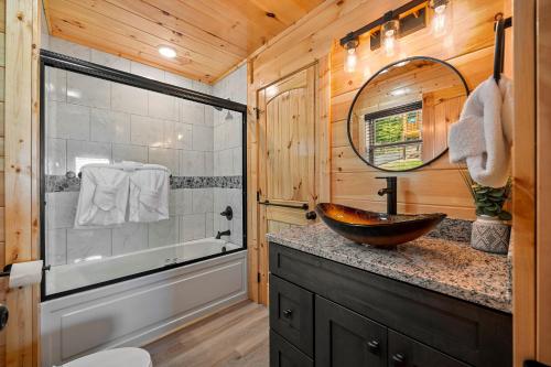 a bathroom with a sink and a tub and a mirror at Heavenly Haven by American Patriot Getaways in Cartertown