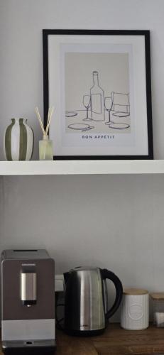 a picture of a coffee maker and a microwave on a shelf at Runo Apartamenty - komfort i widok w centrum miasta in Sanok