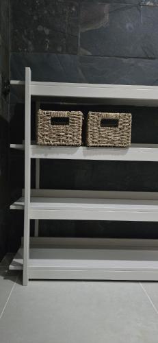 two baskets are sitting on a shelf in a room at Runo Apartamenty - komfort i widok w centrum miasta in Sanok