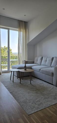 a living room with a couch and a coffee table at Runo Apartamenty - komfort i widok w centrum miasta in Sanok
