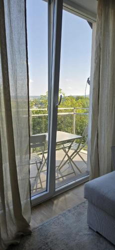 a room with a balcony with a sliding glass door at Runo Apartamenty - komfort i widok w centrum miasta in Sanok