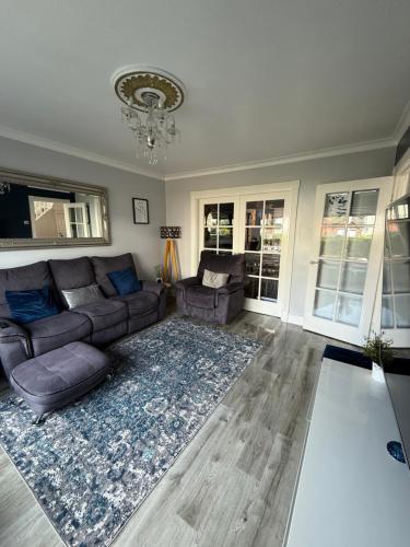 a living room with a couch and a rug at Room at quiet location close to Belfast in Carnmoney