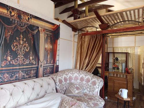 a living room with a couch and a canopy bed at Baltā māja in Rīga