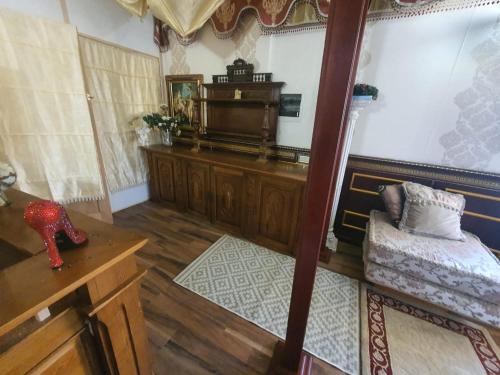 a room with a bed and a desk and a mirror at Baltā māja in Rīga