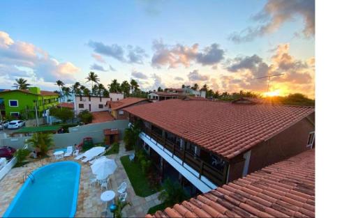 a view of a resort with a pool and a building at Pousada Luz do Porto in Porto De Galinhas