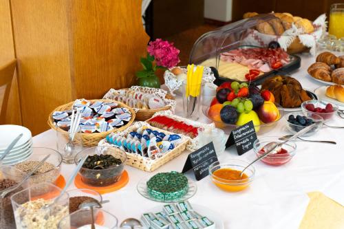 a table with many different types of food on it at Pension Baumgarten in Naturno