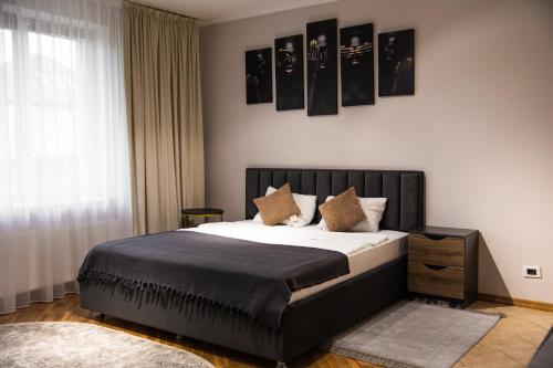 a bedroom with a large bed with white sheets and pillows at Top studio in Chişinău